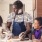 a person and a couple of children cooking