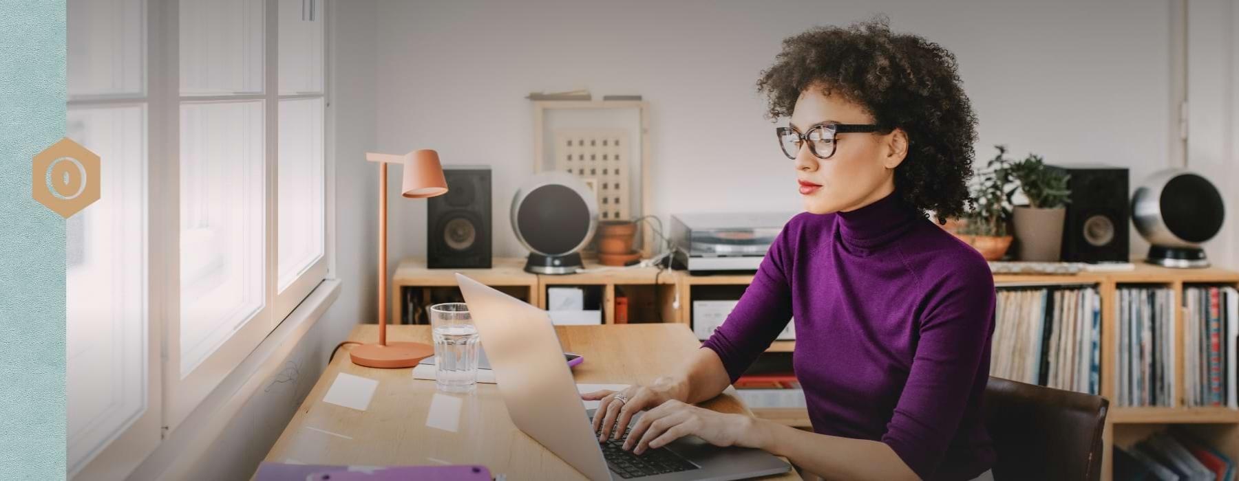 a person sitting at a table with a laptop
